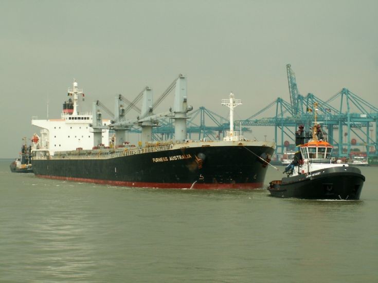 Tugs assisting large bulk carrier
