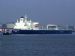 Laden and guided by a tug